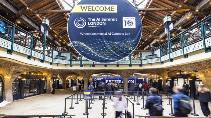 Busy entrance to a UK exhibition venue showing the AI Summit London signage, illustrating the scale and infrastructure of major UK trade shows.