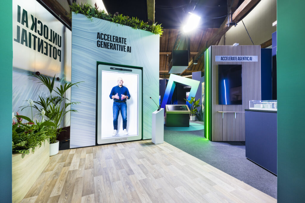 Transparent screen on an exhibition stand overlaying digital content on a life-size figure, demonstrating see-through display technology at a trade show.